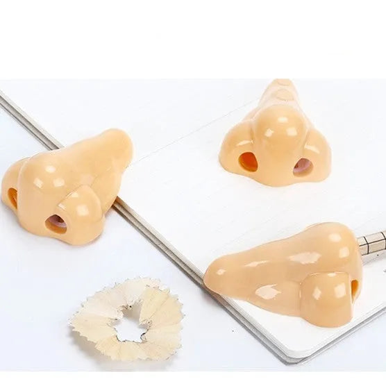 Flesh colour geometric plastic pencil sharpener with big nostril design measuring 58x45x30mm