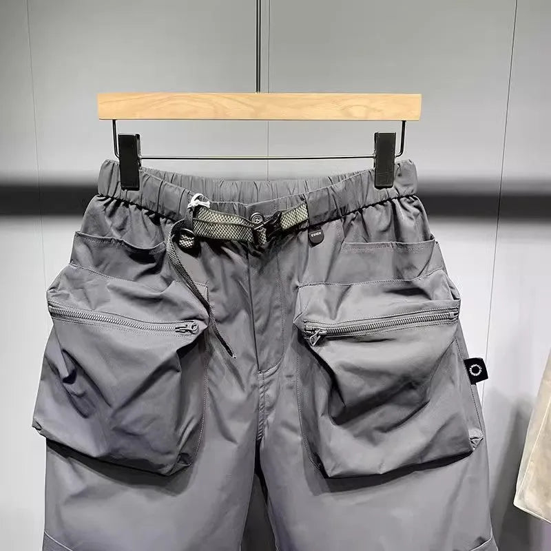 Men's loose fit workwear shorts in black or grey with pockets and straight leg hem available in large sizes