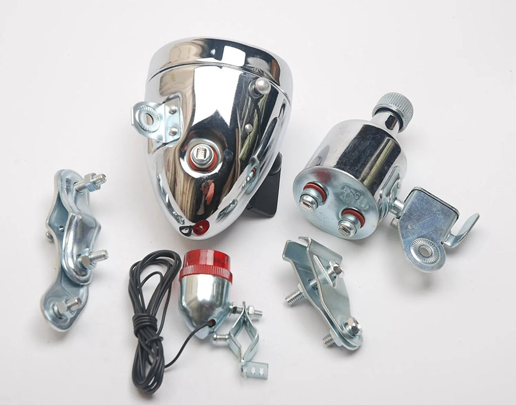 Silver bicycle dynamo generator light kit showing generator unit, wiring, and connectors for front or rear mounting.