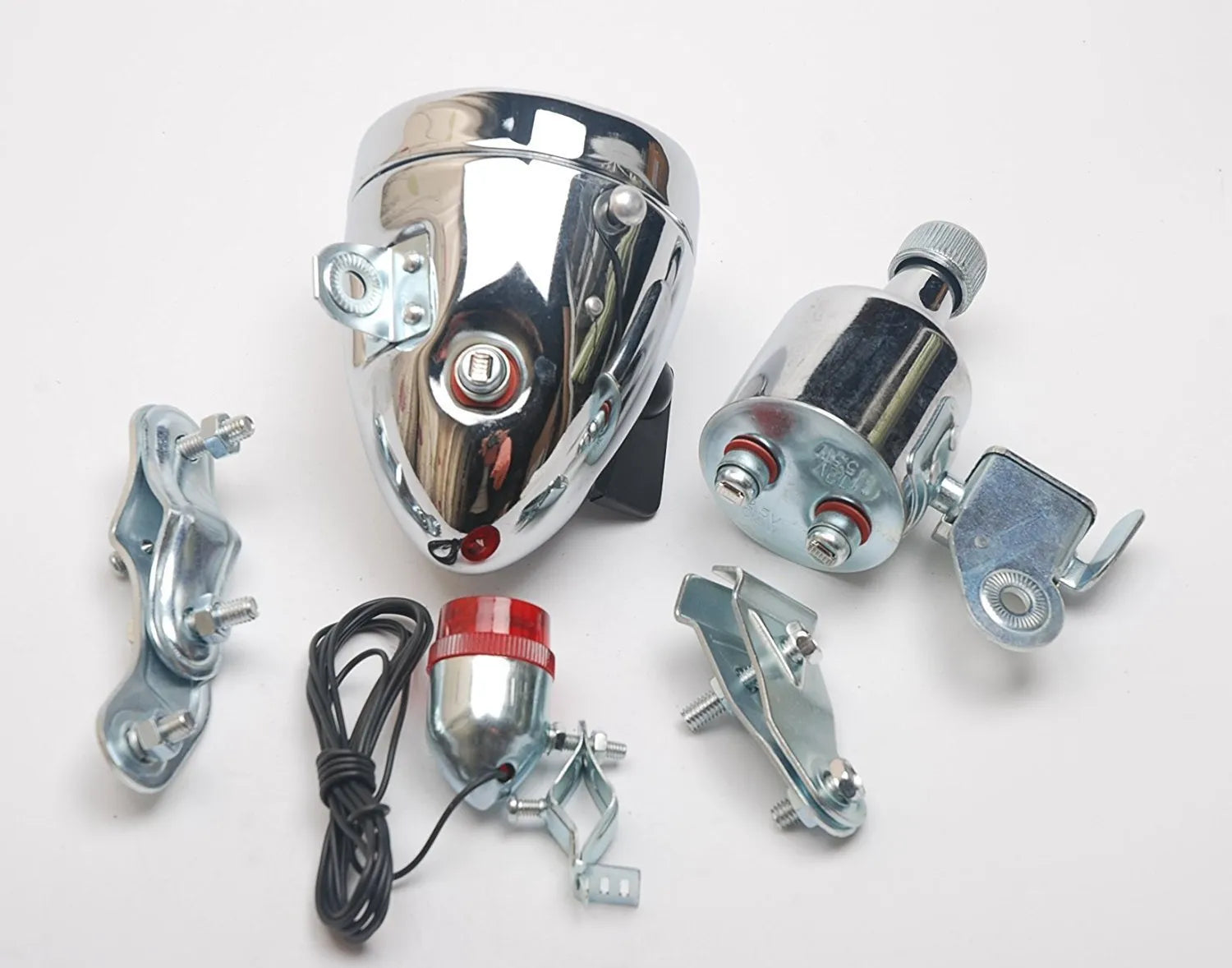 Silver bicycle dynamo generator light kit showing generator unit, wiring, and connectors for front or rear mounting.