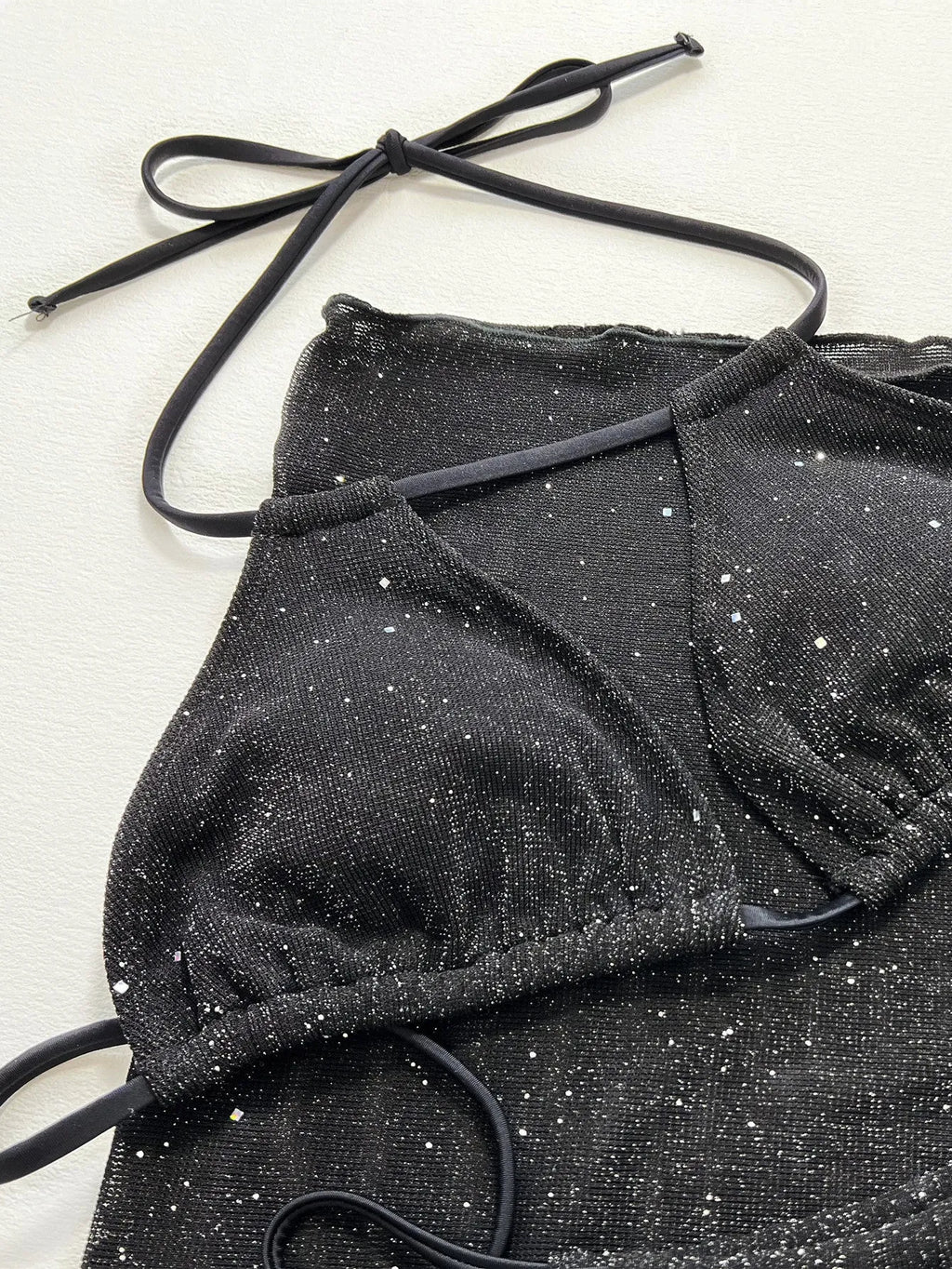 Black three piece bikini set with high waist shorts and top made of polyester fiber