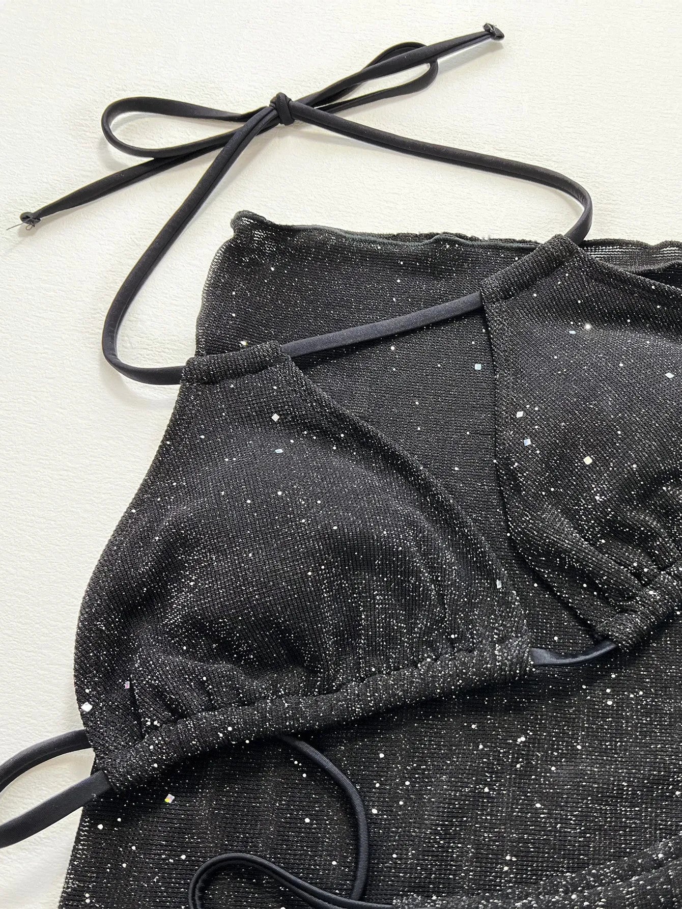 Black three piece bikini set with high waist shorts and top made of polyester fiber