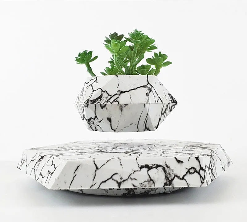 Magnetic levitating plant pot floating in mid-air with marbling colour design