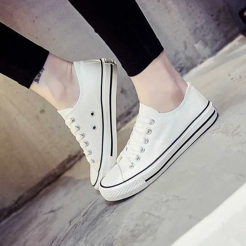 Women's solid colour canvas casual shoes showing available colours: all-black, black, white-black, and white-red.