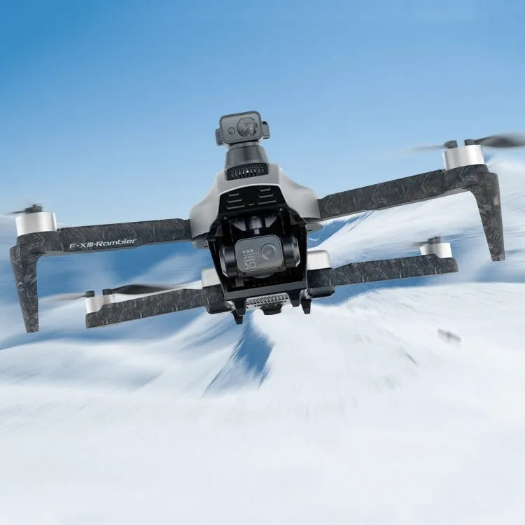 White F13 folding quadcopter drone with camera gimbal, obstacle sensors, and remote controller on a table.