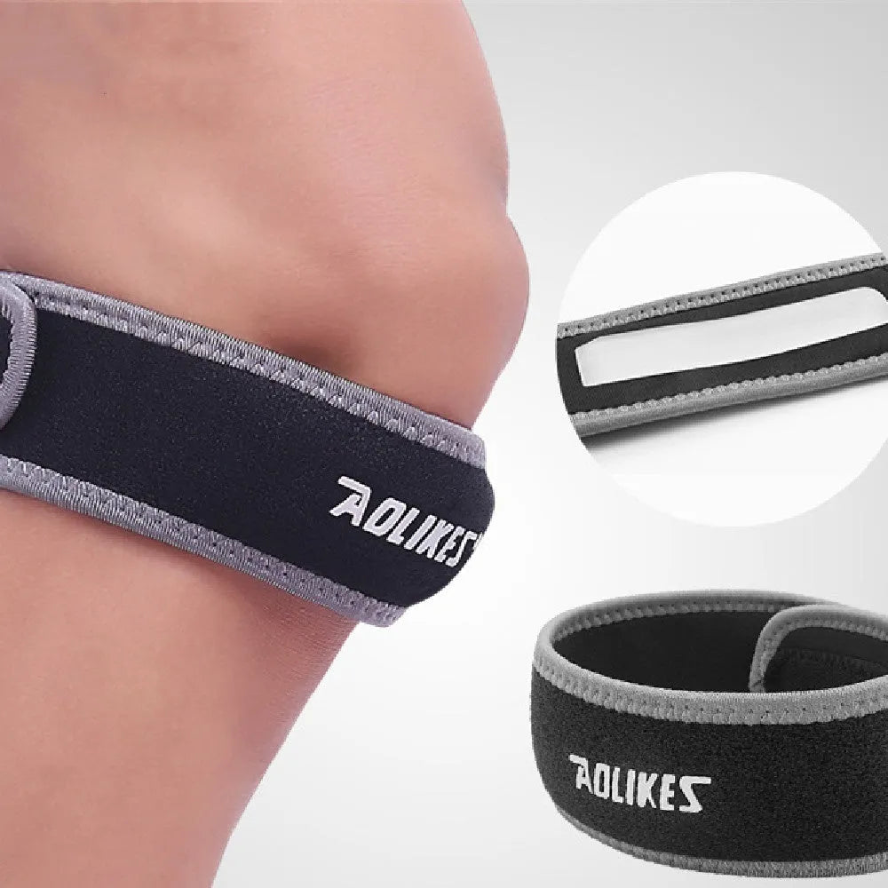 Black and grey patella retinaculum knee support for sports, showing wrap-around design.