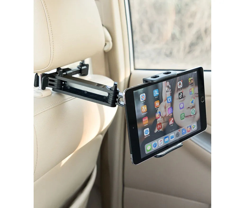 Black car phone holder mounted on vehicle rear seat base with tablet secured in adjustable grip