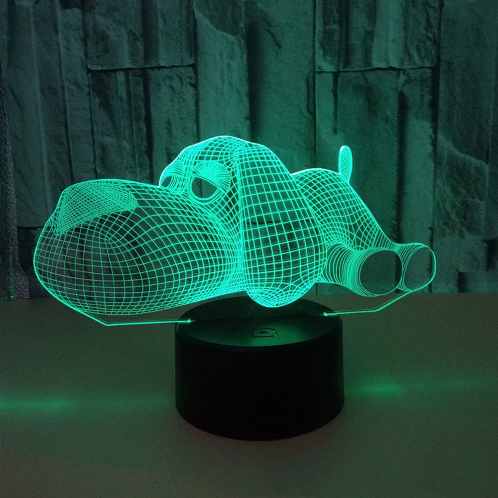 3D illusion dog lamp glowing in multiple colours on a desk with USB cable