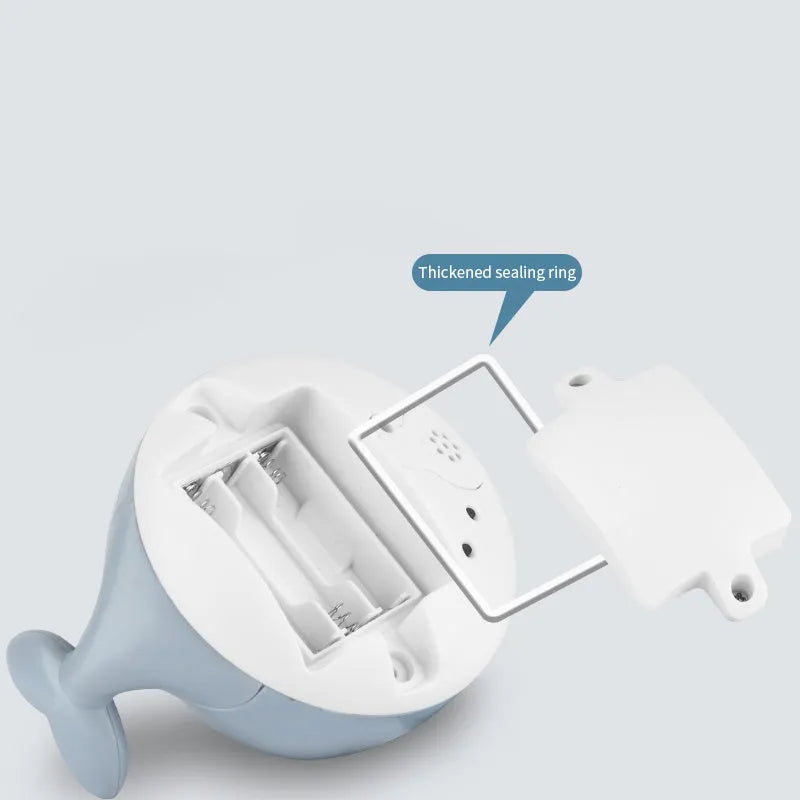 Automatic spray whale bath toy with LED lights floating in water