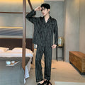 Black striped men's ice silk two-piece pajama set with V-neck top and long trousers.