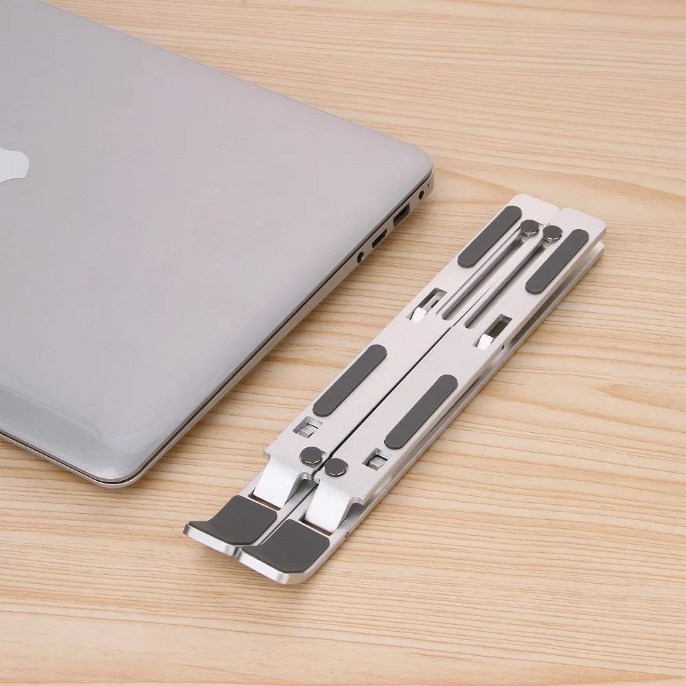 Silver folding laptop stand made from aluminium alloy and silicone for laptops, books and tablets under 16 inches