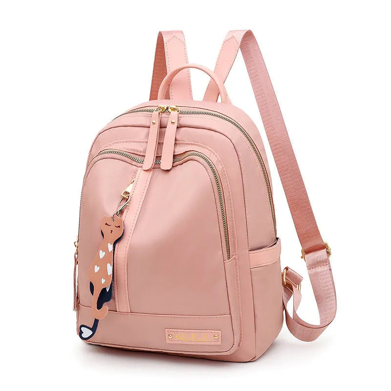 Women's black casual nylon backpack with double straps and a front pocket, shown next to a pink version.