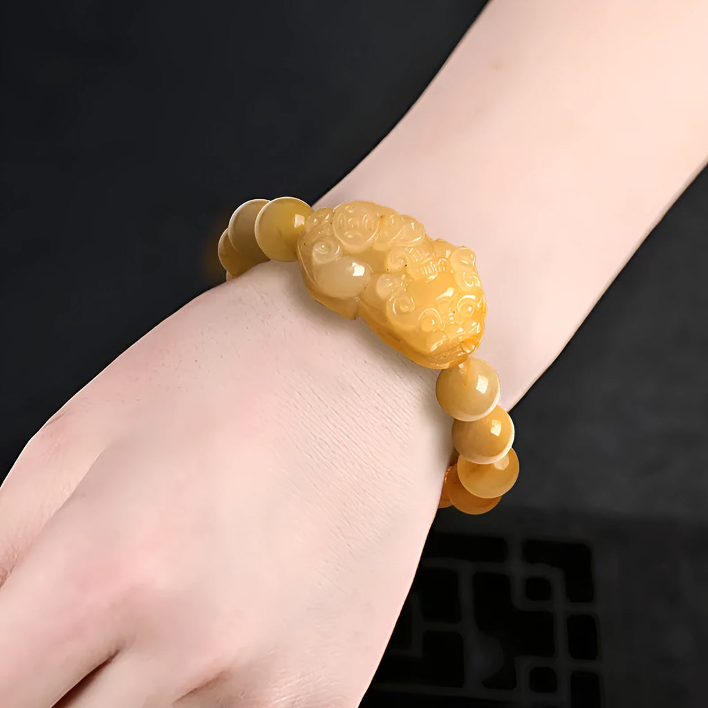 Personalised money symbol bracelet carved from golden thread jade, showing large and small size options.