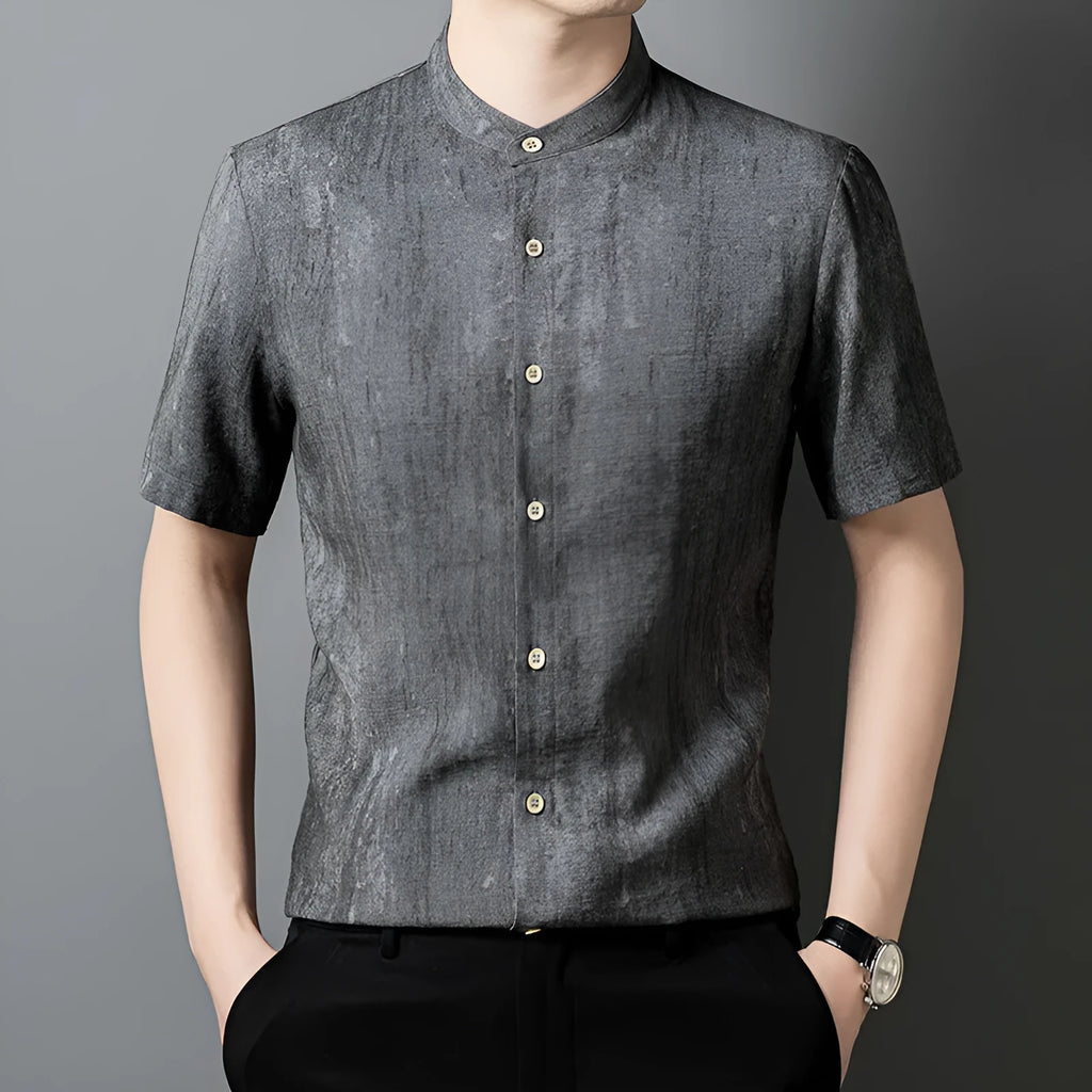 Man wearing a loose-fit black grey linen blend cardigan shirt with a stand collar.