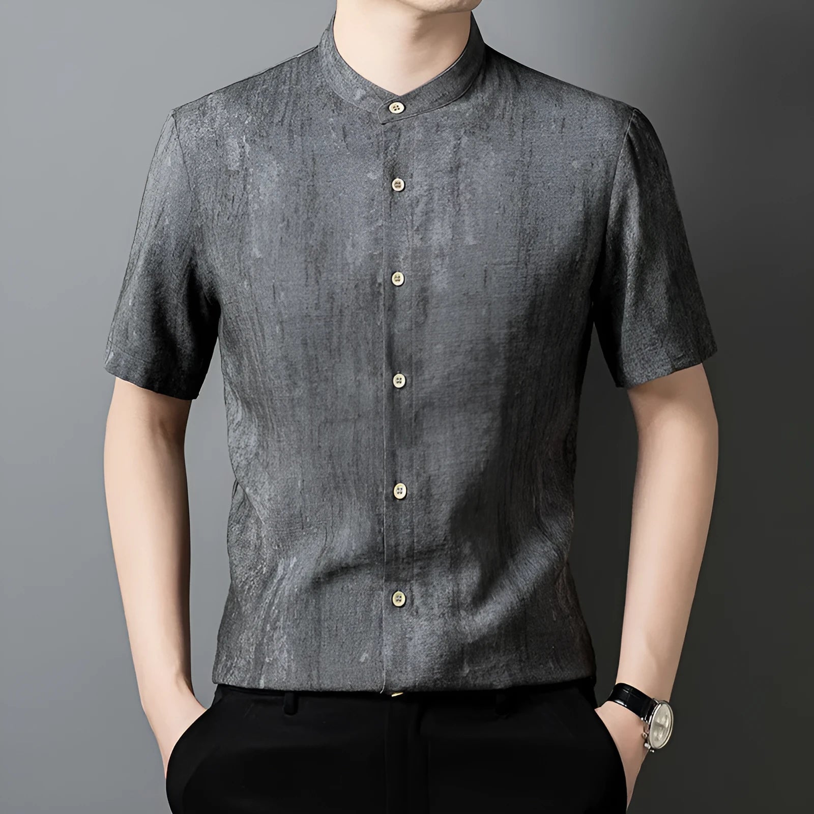Man wearing a loose-fit black grey linen blend cardigan shirt with a stand collar.