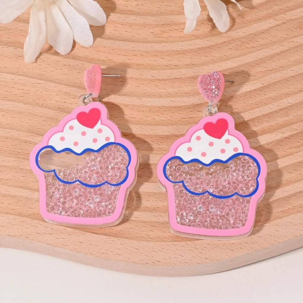 Acrylic drop earrings shaped like a strawberry, cherry, watermelon, pineapple, cake, ice cream, and coconut tree on a white background.