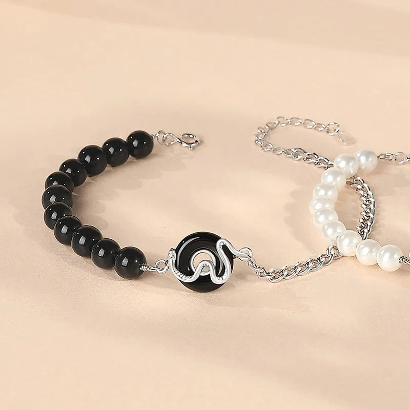 925 sterling silver couple bracelet with snake design and safety buckle on a wrist.