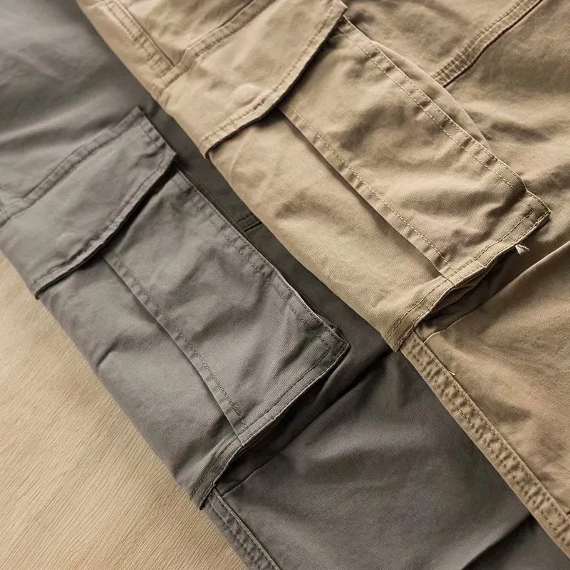Men's solid colour cotton labour protection trousers in cropped length with multiple pockets, shown in khaki.