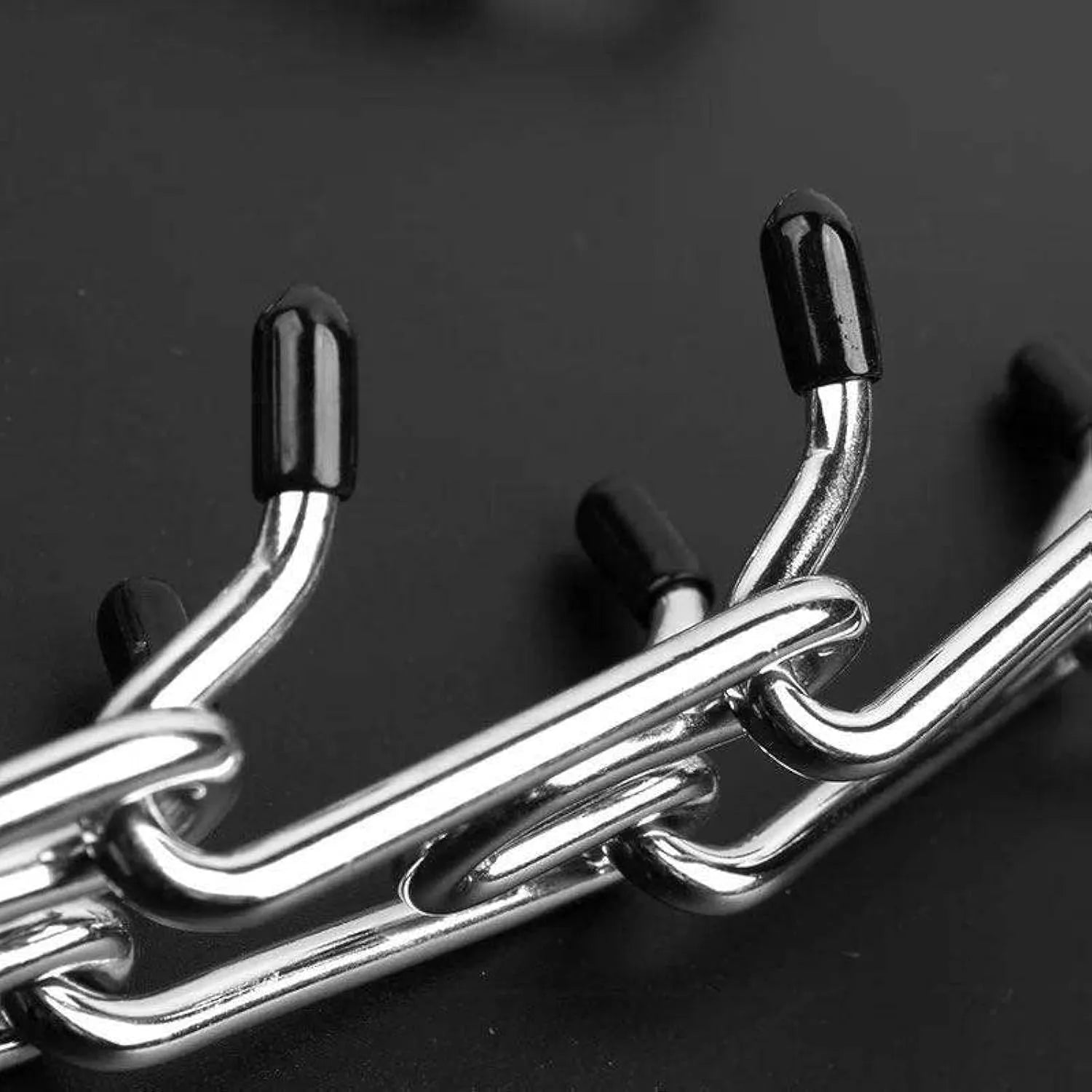 Stainless steel dog training prong collar with rubber tips, showing adjustable chain links.