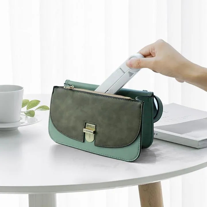 Black foldable tablet holder supporting a smartphone in landscape mode on a desk