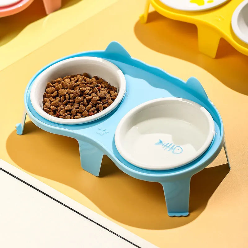 Blue ceramic cat food and water bowl set on a white elevated stand with a storage hook.