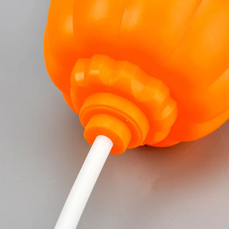 Plastic pumpkin lamp with USB cable showing yellow and purple light options