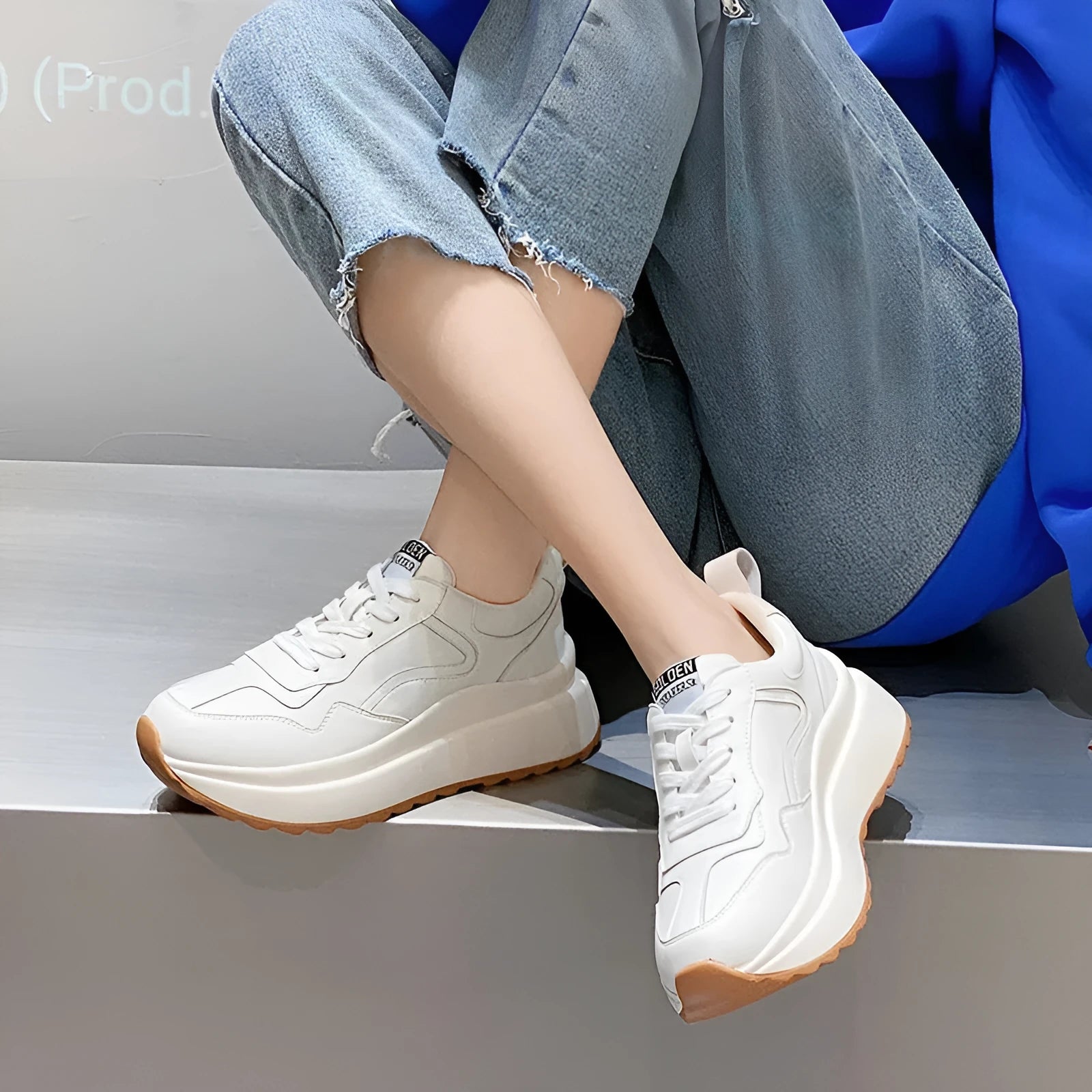 Beige women's cowhide leather low-top sports shoes with cross-strap and visible stitching on a round toe.