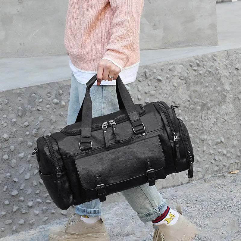 Black PU travel bag with shoe compartment measuring 52cm by 19cm by 27cm