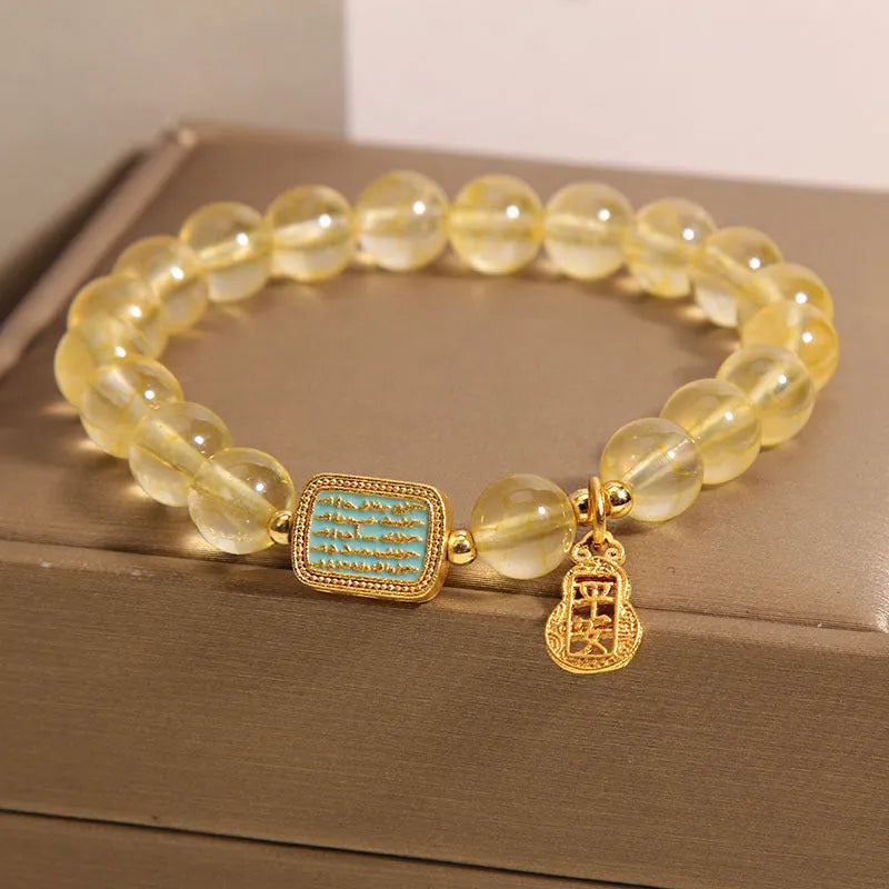 Women's yellow citrine crystal bracelet with rhinestone accents on wrist