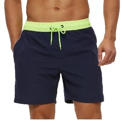 Blue men's fitness shorts with drawstring waist, pockets, and a zipper on a neutral background.