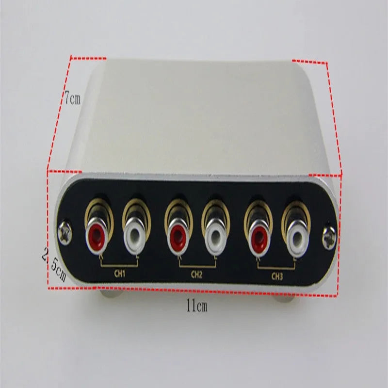 Silver aluminium audio source selector switch box with front button and infrared remote control.