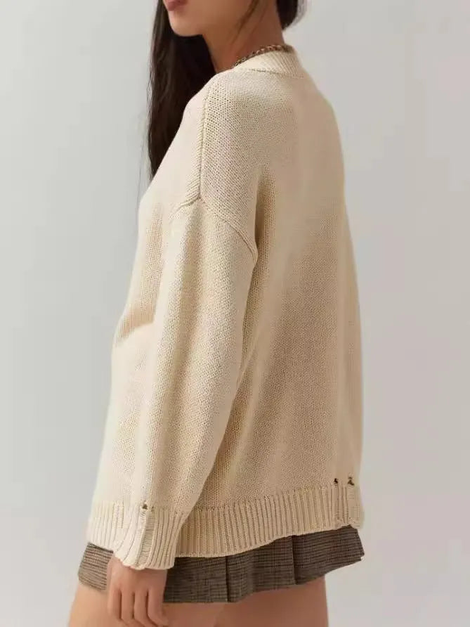 Women's milky white acrylic jacquard knit pullover sweater with round neck and long sleeves.