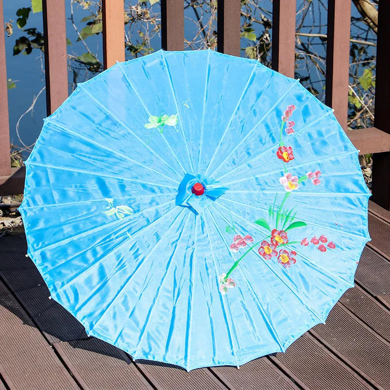 Handmade Chinese-style silk dance umbrella with wooden pole, available in ten colours and four diameters.