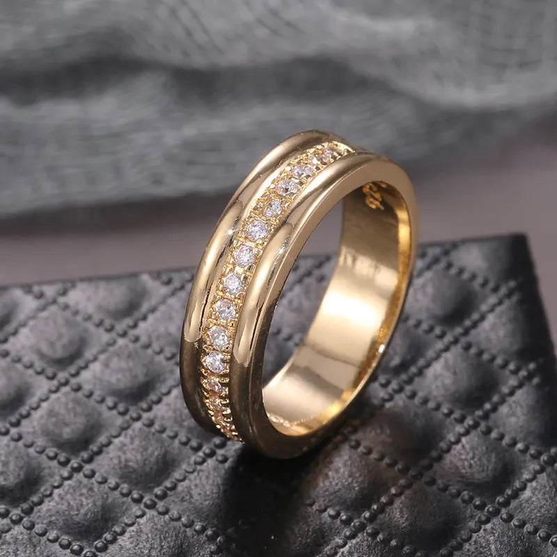 Gold plated copper geometric ring with inlaid zircon stone on white background
