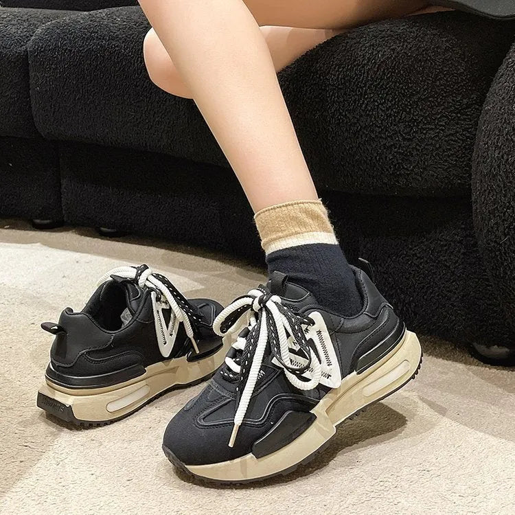 Women's black retro platform sports shoes with lace-up front and round toe on a rubber sole.