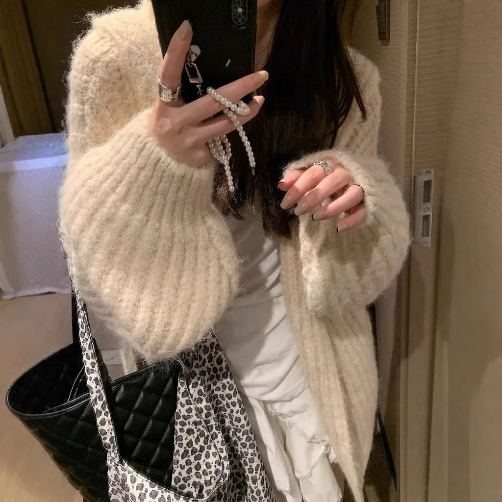A loose-fit, thick acrylic hooded cardigan sweater for women, shown in a macaron colour.