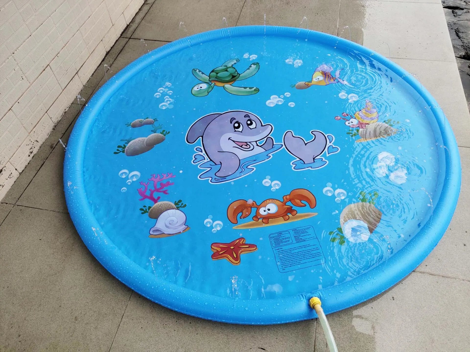 Blue PVC water spray play mat with marine animal designs for outdoor garden use