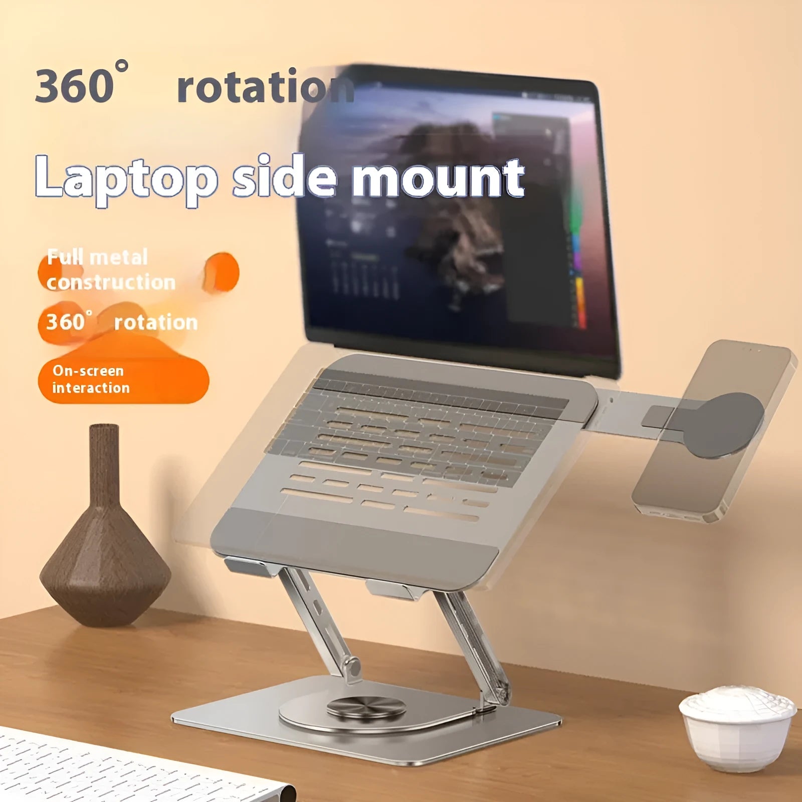 Silver carbon steel laptop stand with a rotatable magnetic phone holder attached, shown supporting a laptop.