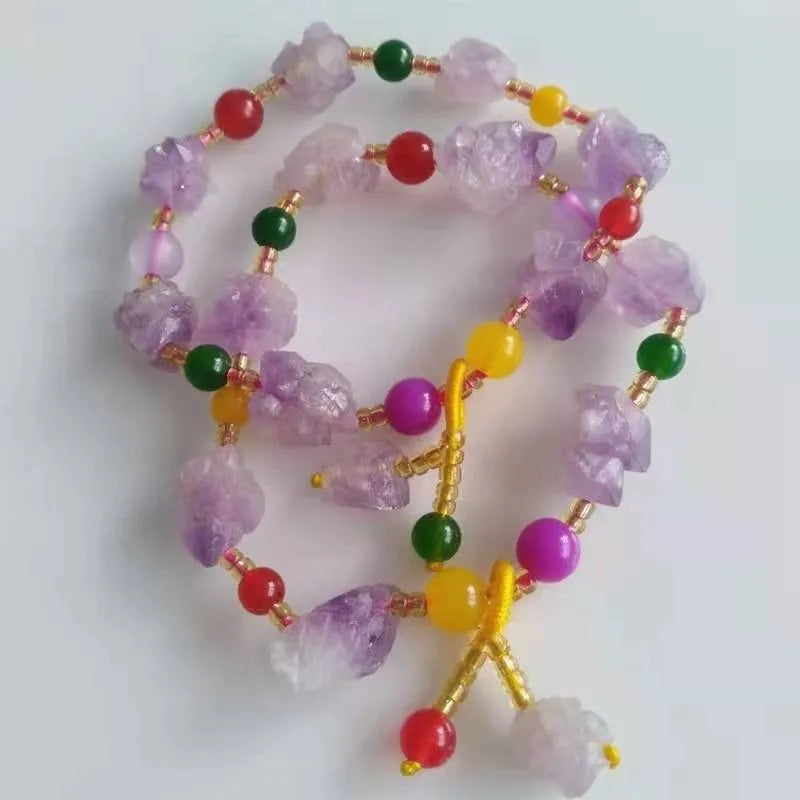 Natural shaped amethyst bead bracelet with a fu character charm on a white background
