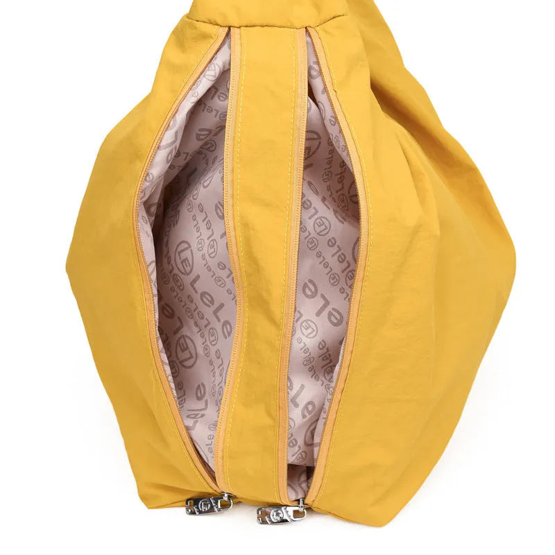 Soft heart-shaped nylon underarm bag for women in black, shown with a crossbody strap.
