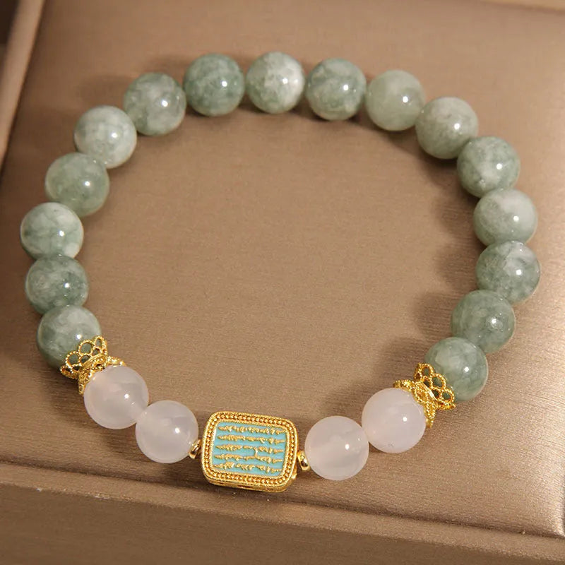 Oil green emerald crystal bracelet with five engraved Buddhist scripture beads on female wrist