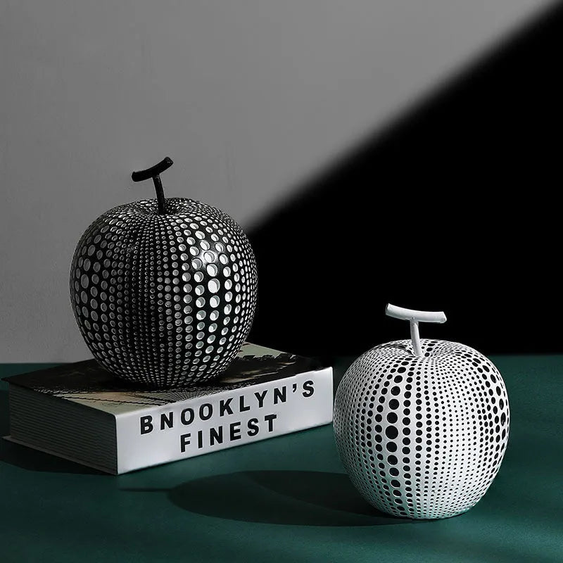 Resin craft decorative apple sculpture in black tall model with smooth finish on a white table
