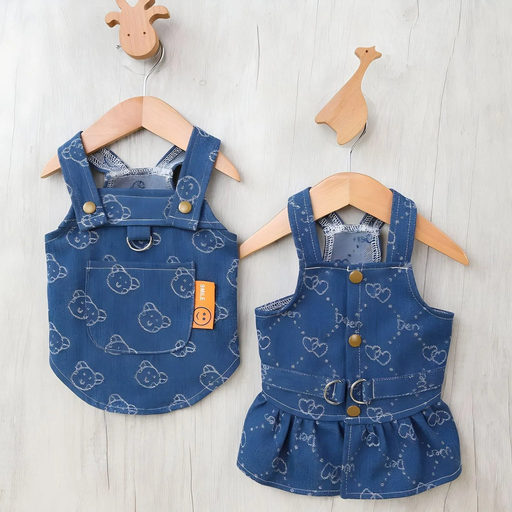 Small white Bichon dog wearing a denim princess dress with bracket skirt design
