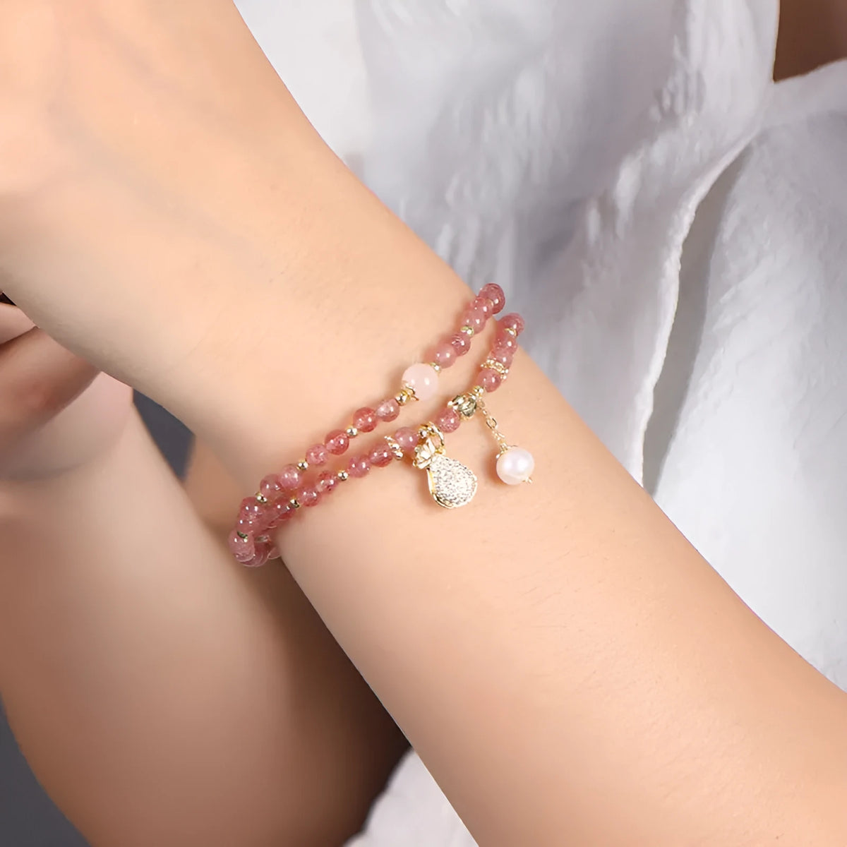 Strawberry quartz crystal bracelet with geometric pink beads on adjustable string