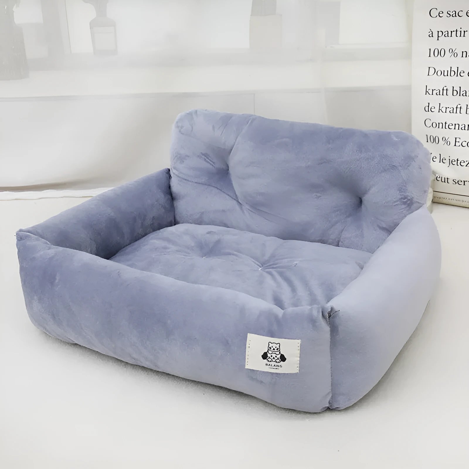 Car-mounted pet travel nest in grey and blue plaid colours showing stain-resistant cloth construction