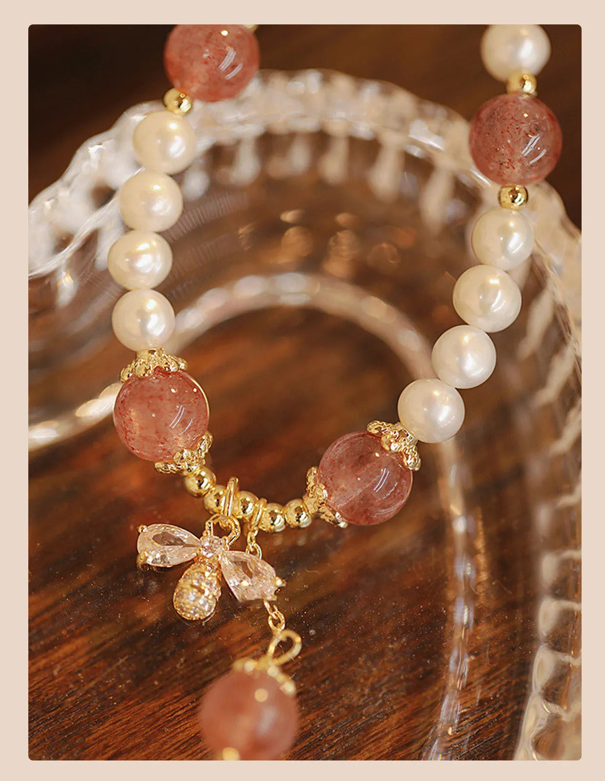 Women's strawberry quartz crystal bracelet with bow detail on wrist