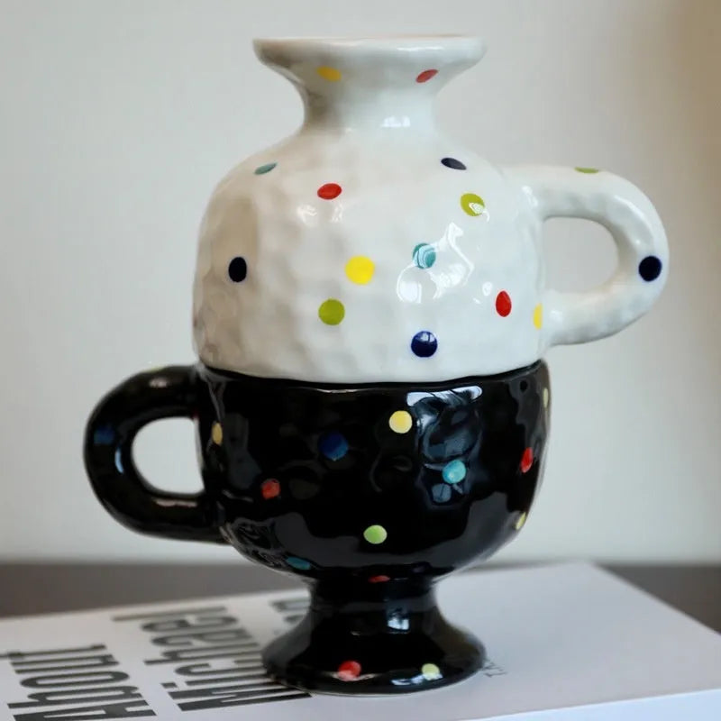 Hand-pinched irregular shaped solid colour ceramic mug on a table, showing its unique form and modern simplicity design.