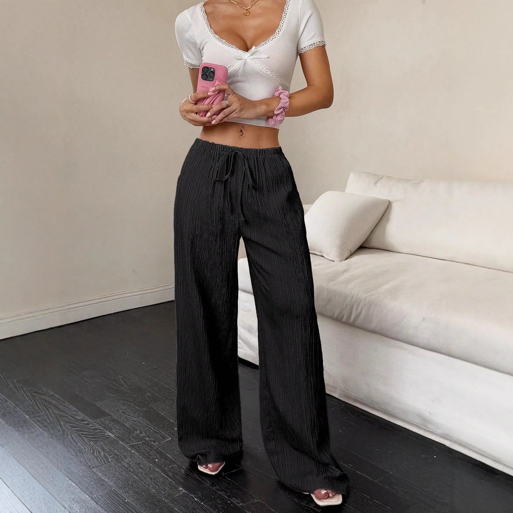 Women's black wide leg trousers with lace-up waist detailing on mid-rise waist