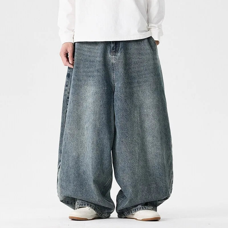 Men's plus size wide leg baggy jeans in black denim on a hanger
