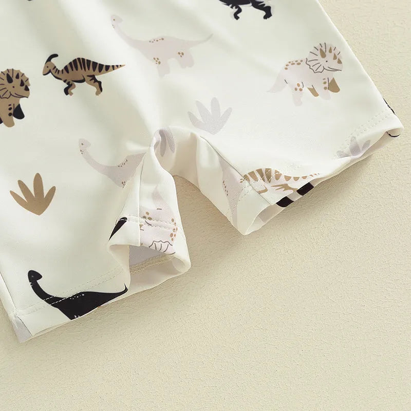 Children's polyester swimsuit in peacock green white coconut tree print and ivory white black coffee dinosaur print, sizes 70-110